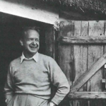 Dag Hammarskjöld standing in front of a barn.