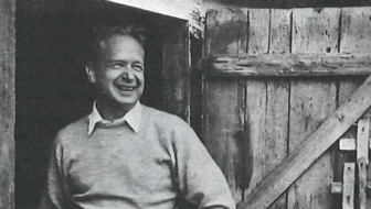 Dag Hammarskjöld standing in front of a barn.